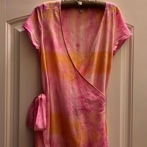 Calypso wraparound short sleeve dress pink, orange, and white tie-dye